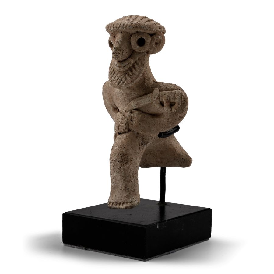 Western Asiatic Terracotta Seated Male Figure Holding an Axe