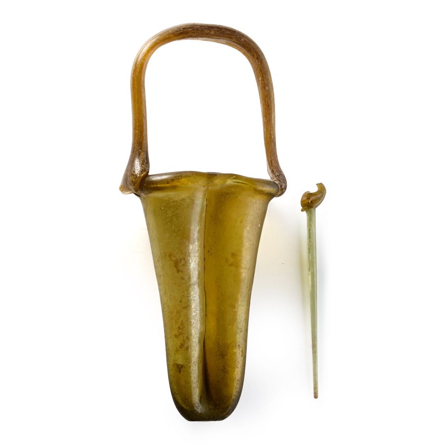 Roman Amber Glass Double Unguentarium with Dolphin-Headed Pin